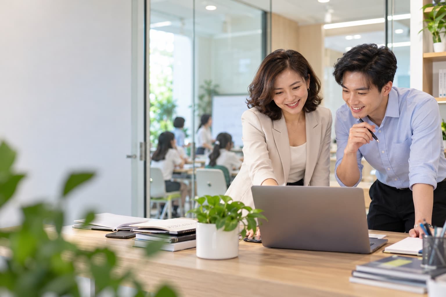 Giám đốc trung tâm và giáo viên cùng xem dữ liệu lớp học trên máy tính